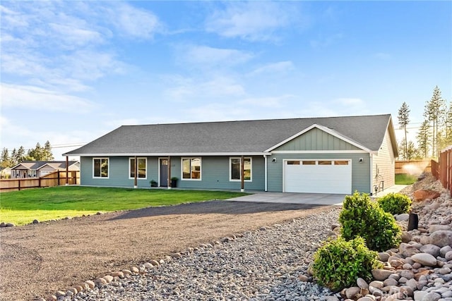 single story home with a garage and a front lawn