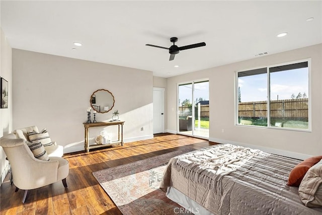 bedroom featuring access to outside, ceiling fan, and dark wood-type flooring