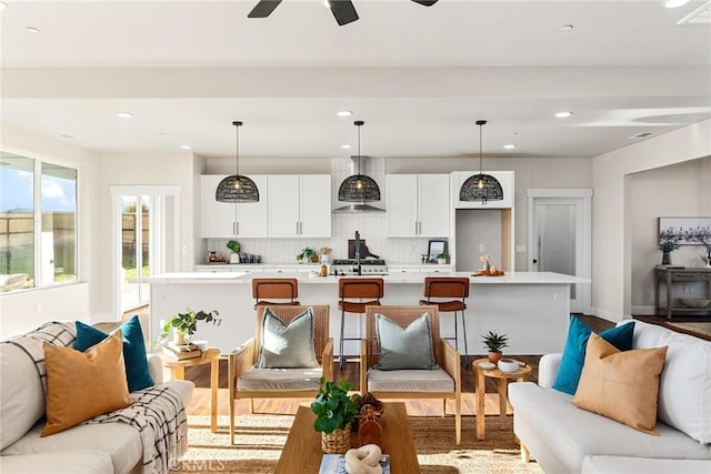 living room featuring light hardwood / wood-style floors and ceiling fan