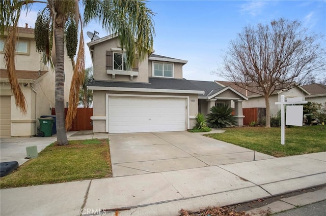 view of front of property with a front yard and a garage