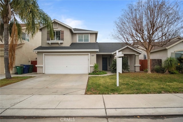 view of front of home with a front yard and a garage