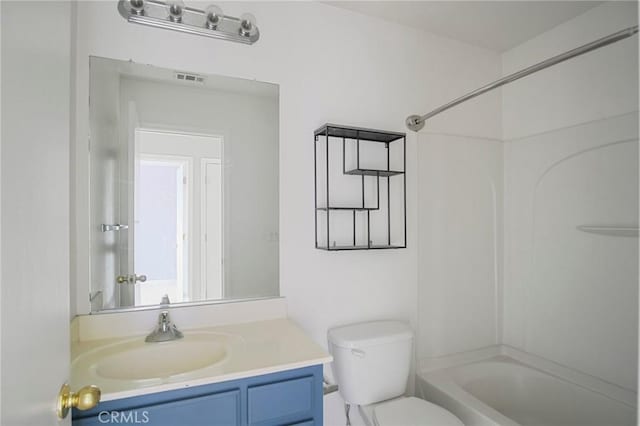 full bathroom with toilet, vanity, and shower / washtub combination