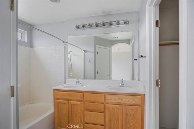 bathroom featuring shower / bathtub combination and vanity