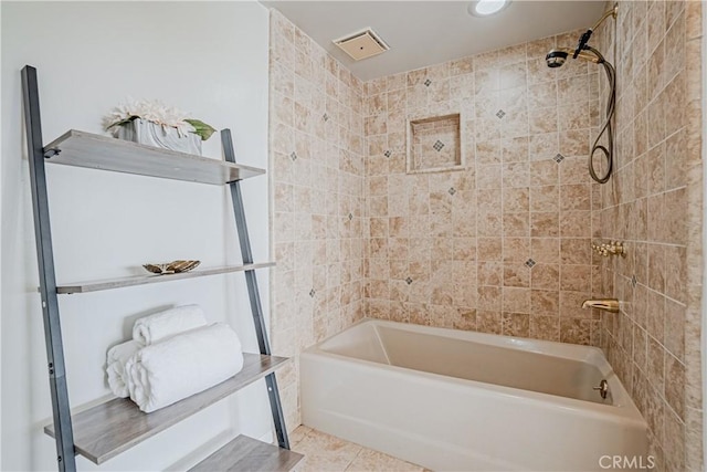 bathroom featuring tiled shower / bath combo and tile patterned floors