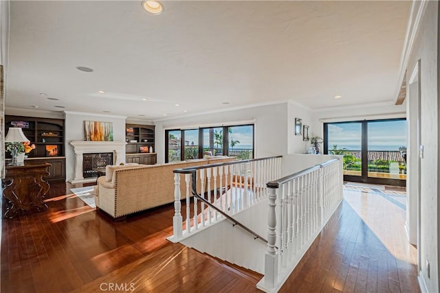 hallway with hardwood / wood-style floors and crown molding