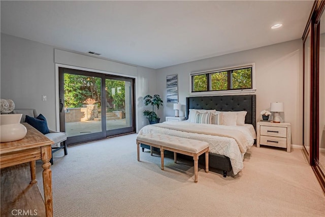 bedroom featuring access to exterior, light colored carpet, and multiple windows