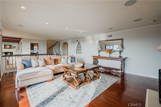 living room with ornamental molding and dark hardwood / wood-style flooring