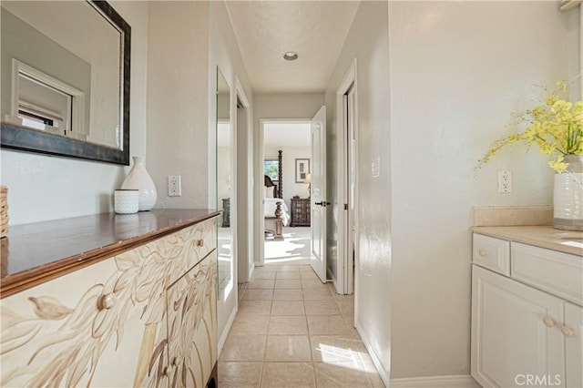 corridor with light tile patterned flooring