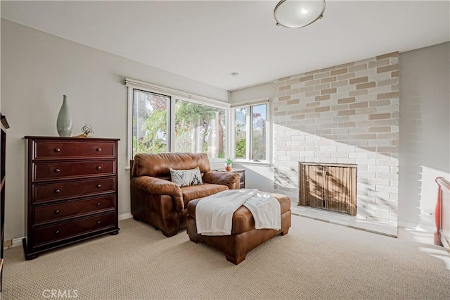 sitting room featuring light carpet and a fireplace