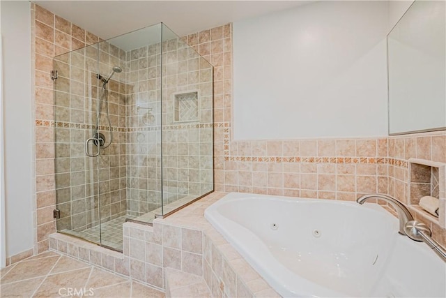 bathroom with independent shower and bath and tile patterned floors