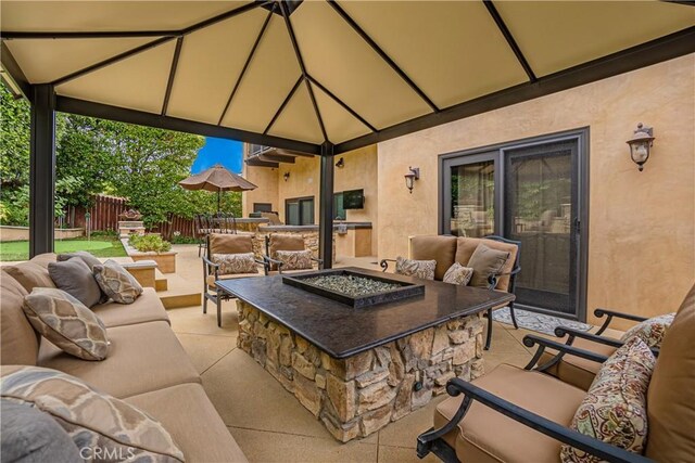 view of patio / terrace with an outdoor living space with a fire pit