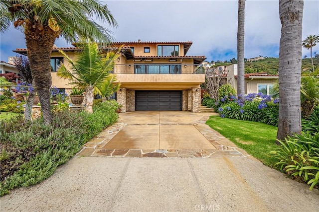 view of front of property with a balcony and a garage