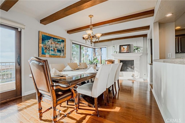 dining space with light hardwood / wood-style flooring, beam ceiling, and a notable chandelier