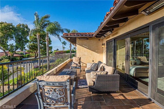 view of patio with outdoor lounge area and a balcony