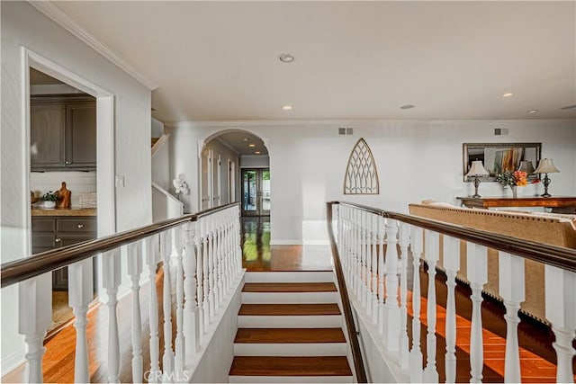 hall featuring light hardwood / wood-style flooring and crown molding