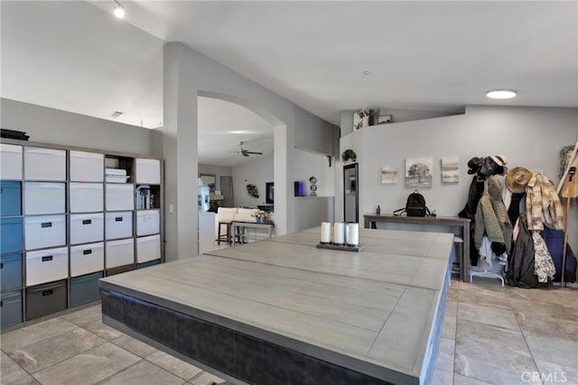 interior space featuring ceiling fan and lofted ceiling