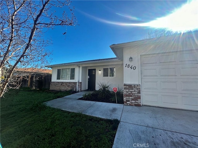 ranch-style home with a front lawn and a garage