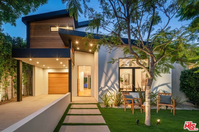 exterior space featuring a lawn and a garage