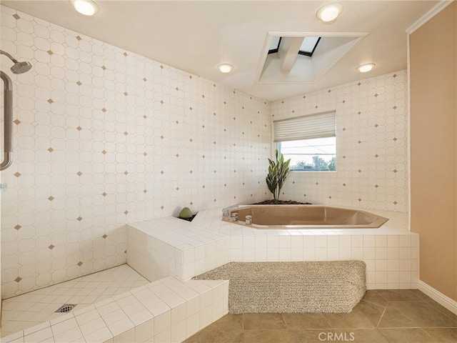 bathroom with tiled shower and tile patterned flooring