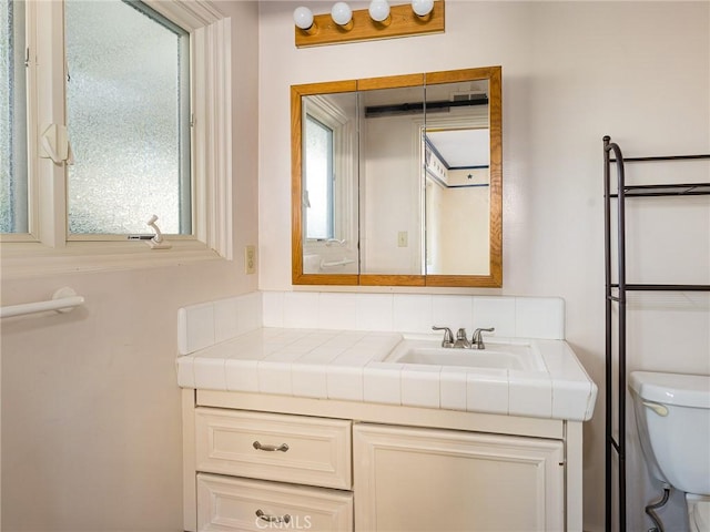 bathroom featuring toilet and vanity