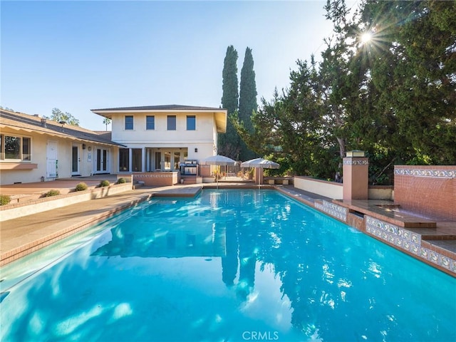 view of swimming pool featuring a patio area