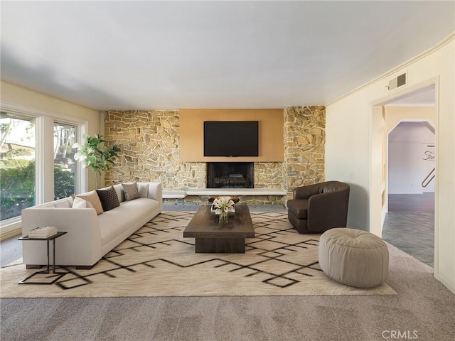 carpeted living room featuring a fireplace