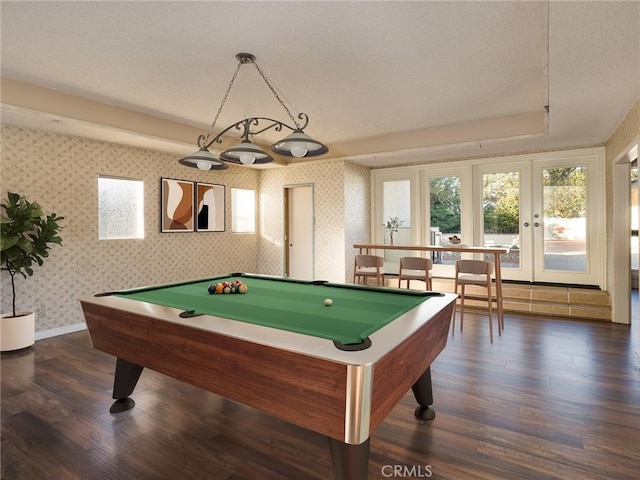 game room with dark wood-type flooring, a textured ceiling, and pool table