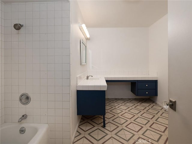 bathroom with tiled shower / bath combo and vanity