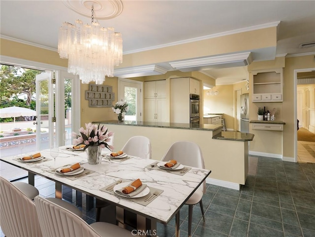 tiled dining area featuring crown molding and an inviting chandelier