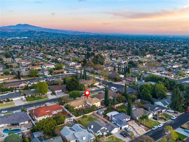 aerial view at dusk featuring a mountain view