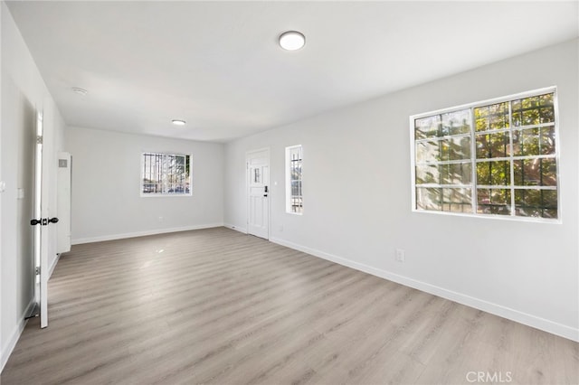 unfurnished room with light wood-type flooring