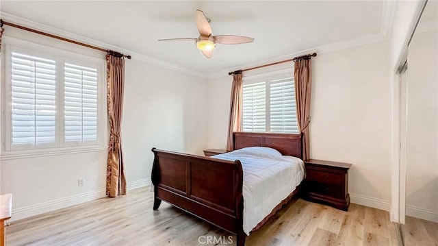 bedroom featuring crown molding, ceiling fan, and light wood-type flooring