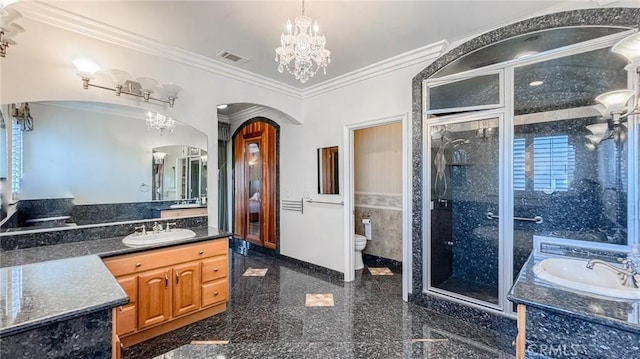 bathroom with crown molding, an enclosed shower, vanity, toilet, and a chandelier