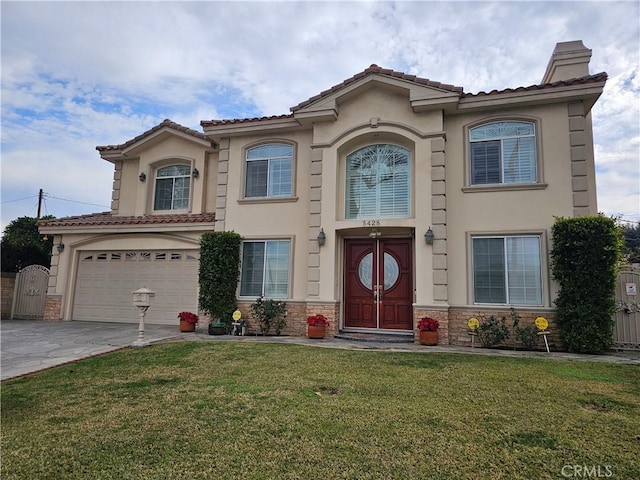 mediterranean / spanish home featuring a garage and a front yard