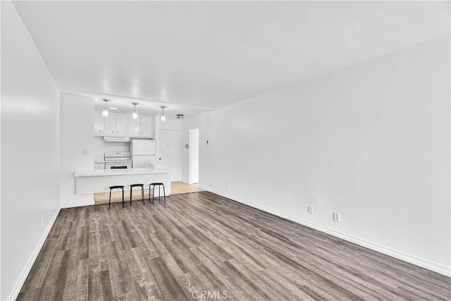 unfurnished living room featuring hardwood / wood-style flooring