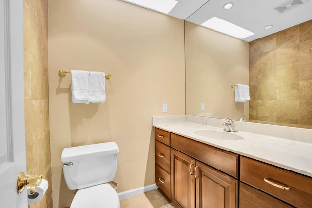 bathroom with tile patterned floors, toilet, and vanity