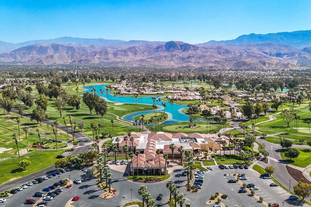 birds eye view of property with a water and mountain view