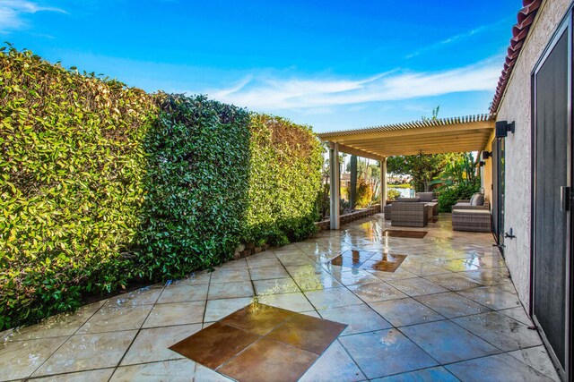 view of patio featuring outdoor lounge area and a pergola