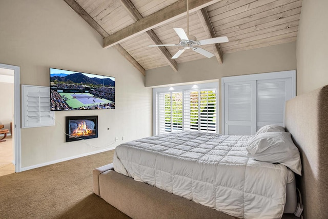 bedroom featuring ceiling fan, carpet, lofted ceiling with beams, and wood ceiling