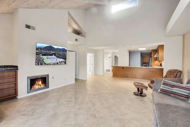 tiled living room featuring high vaulted ceiling and beamed ceiling