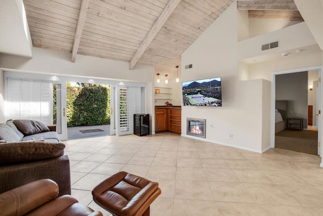 living room with high vaulted ceiling, wooden ceiling, light tile patterned floors, and beamed ceiling