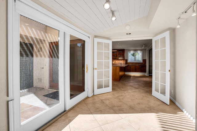 interior space featuring wooden ceiling, light tile patterned floors, lofted ceiling, and french doors