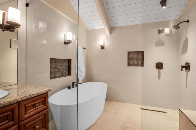 bathroom featuring tile patterned flooring, vanity, tile walls, lofted ceiling with beams, and plus walk in shower