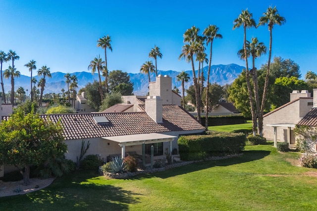 exterior space with a mountain view and a yard