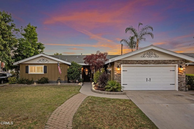 ranch-style home with a lawn and a garage