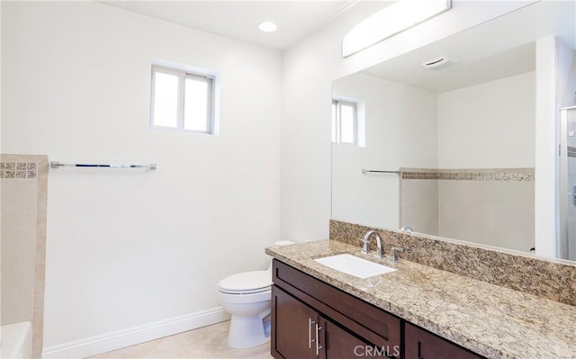 bathroom with tile patterned floors, toilet, vanity, and a tile shower