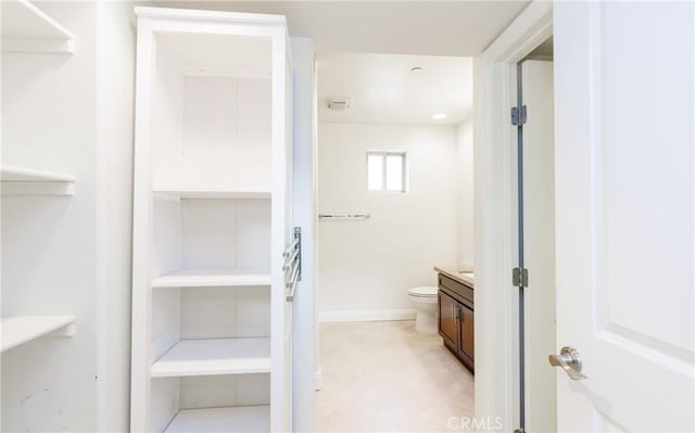 bathroom featuring toilet and vanity