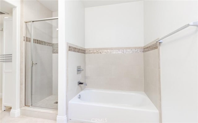 bathroom featuring plus walk in shower and tile patterned floors