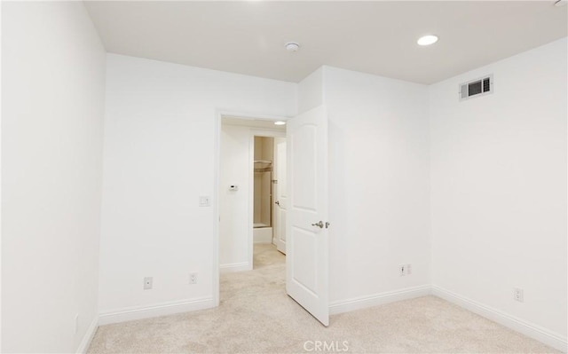 unfurnished room featuring light colored carpet