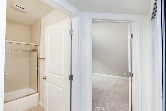 bathroom with bath / shower combo with glass door